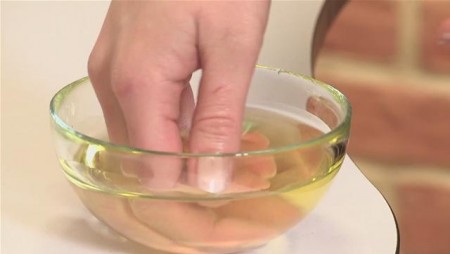 Application de l'huile de ricin sur les ongles